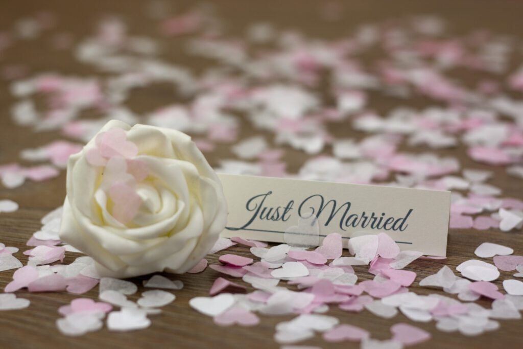 A rose surrounded by petals with a Just Married tag